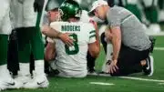 BREAKING: The curse of the Jets lives! Aaron Rodgers carted off field